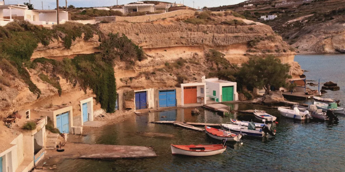 Boat houses painted in bright colours at the water's edge